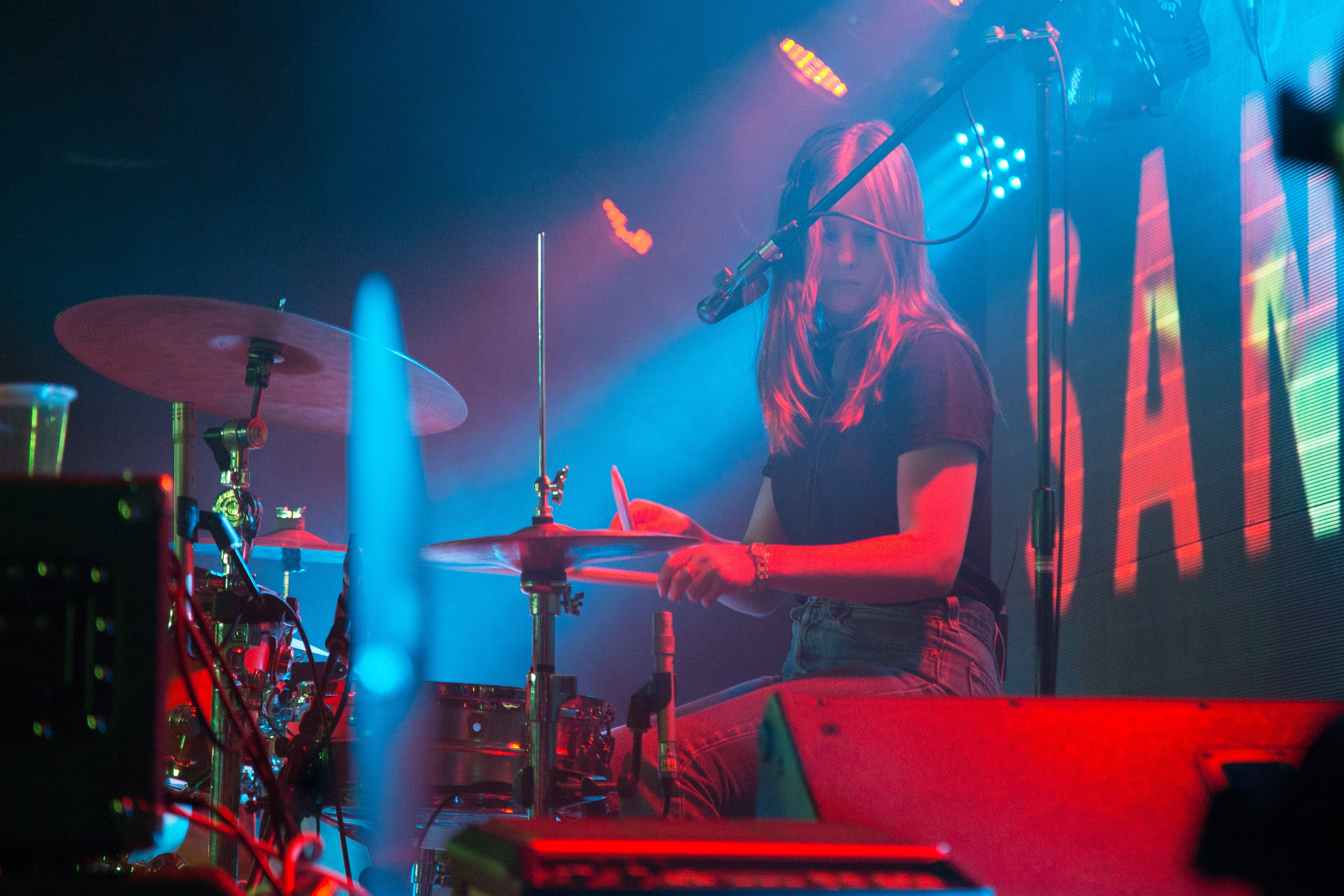 girl playing drums on stage