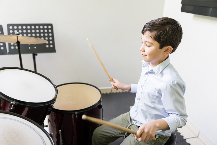 Kid Playing Drum In Music School