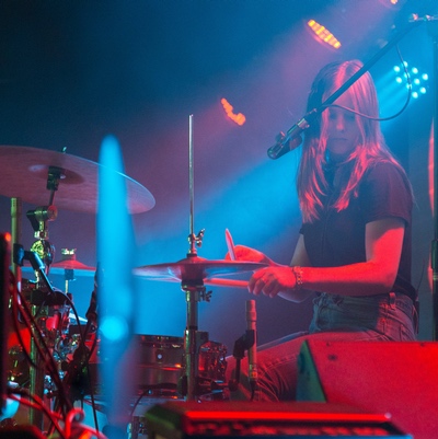 girl drumming on stage