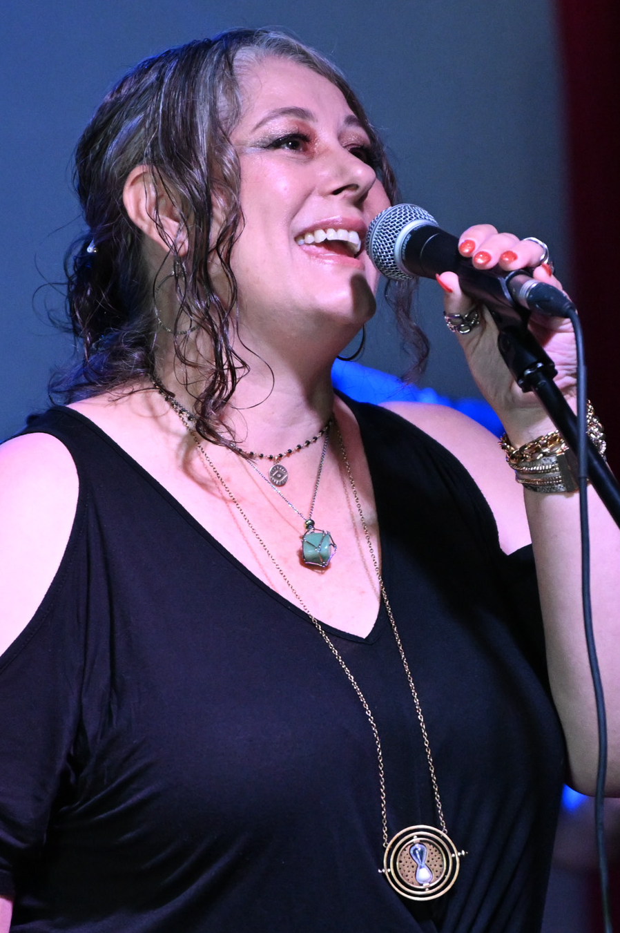 Adult woman singing on stage